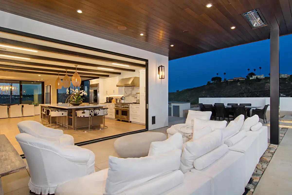 outside living space by a modern kitchen at night